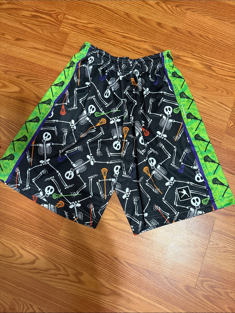 LaCrosse Black Skeleton Lacrosse Graphic Athletic Shorts with Green Side Panels